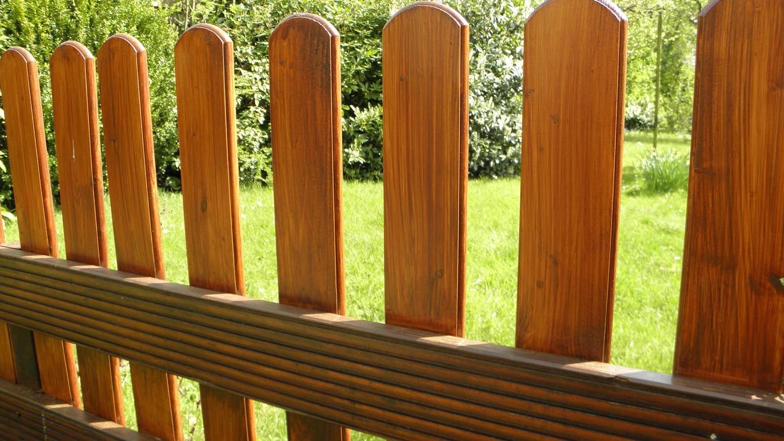 A timber garden fence beside a lawn